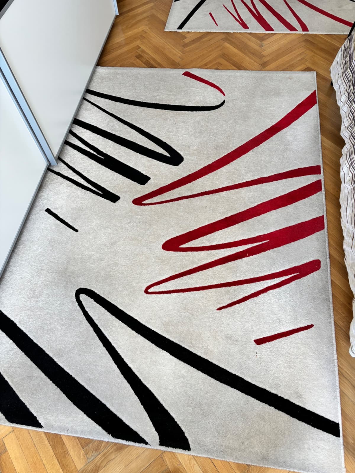 Béžový koberec s červenými a černými abstraktními motivy - 1